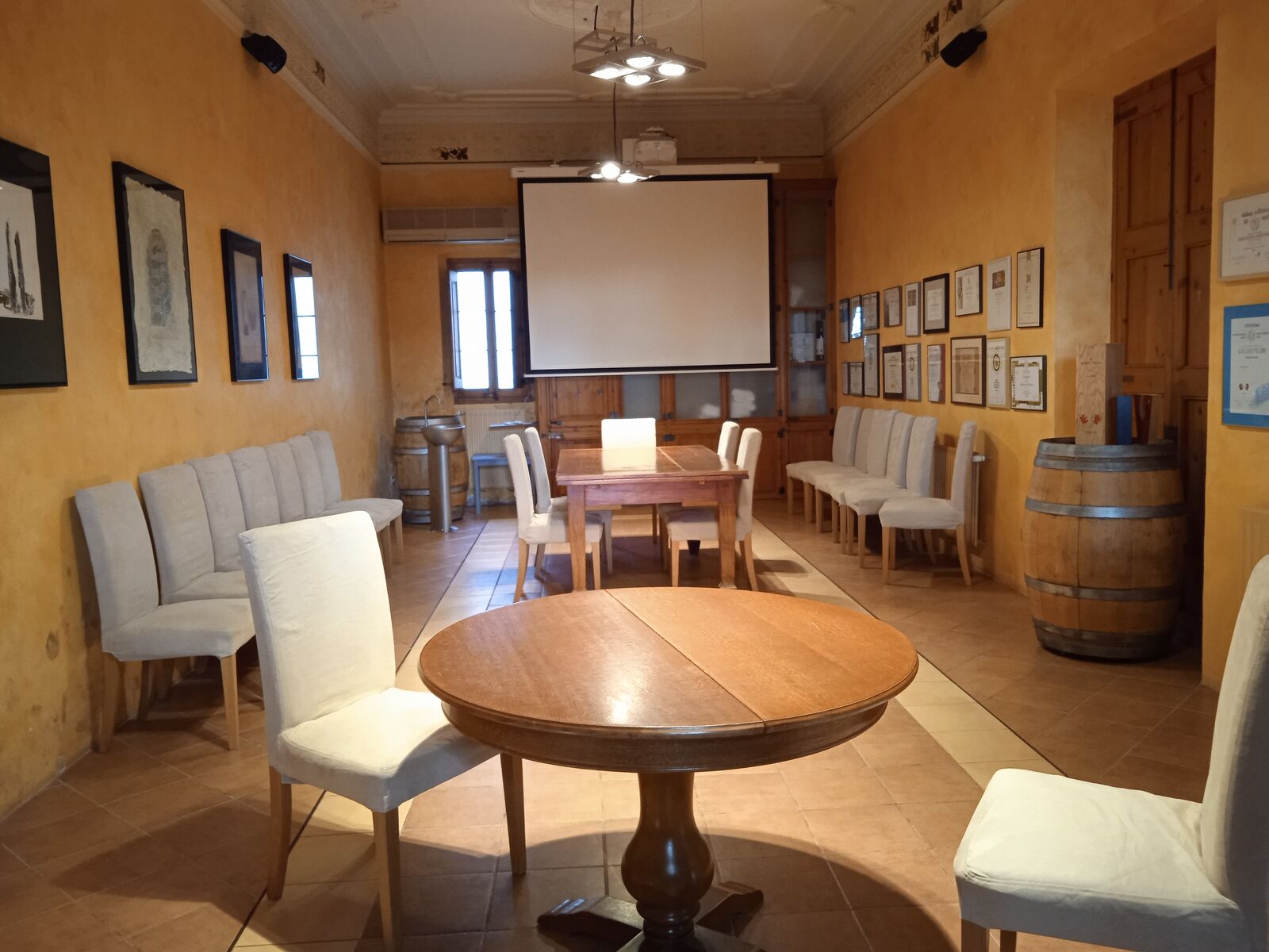 The Xarel·lo room at Albet i Noya, with a projector, barrels and wooden tables